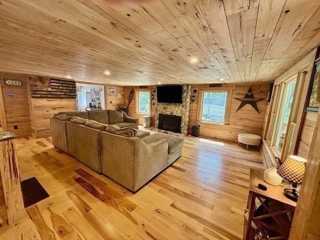 80 Populatic St, Franklin, MA 02038 - living area featuring wood ceiling, wood walls, hardwood / wood-style floors, and a fireplace