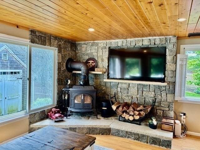 80 Populatic St, Franklin, MA 02038 - living room with wooden ceiling, healthy amount of natural light, wood finished floors, a wood stove, and baseboards