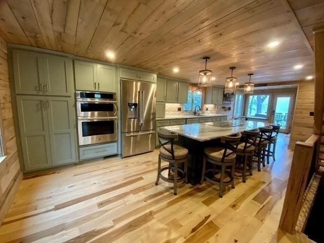 80 Populatic St, Franklin, MA 02038 - kitchen featuring stainless steel appliances, wood ceiling, light countertops, a sink, and light wood-type flooring