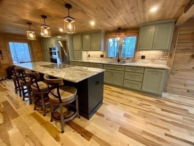 80 Populatic St, Franklin, MA 02038 - kitchen with wooden ceiling, a sink, stainless steel refrigerator, black electric stovetop, and light wood-style flooring