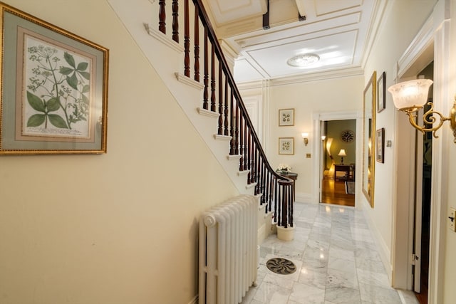 entryway with radiator and crown molding