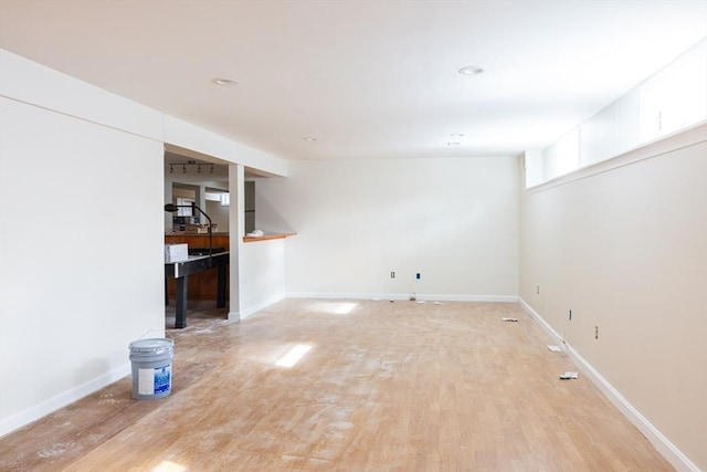 interior space with light wood finished floors and baseboards