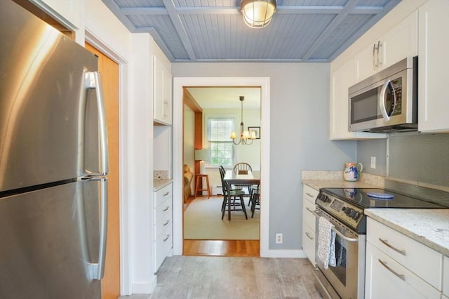 110 Teaticket Path, Falmouth, MA 02536 - kitchen featuring appliances with stainless steel finishes, light wood-type flooring, white cabinetry, a chandelier, and wooden ceiling