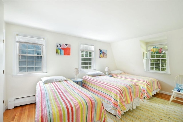 110 Teaticket Path, Falmouth, MA 02536 - bedroom featuring baseboard heating and wood finished floors