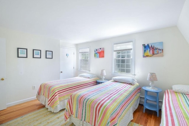 110 Teaticket Path, Falmouth, MA 02536 - bedroom with wood finished floors and a baseboard heating unit