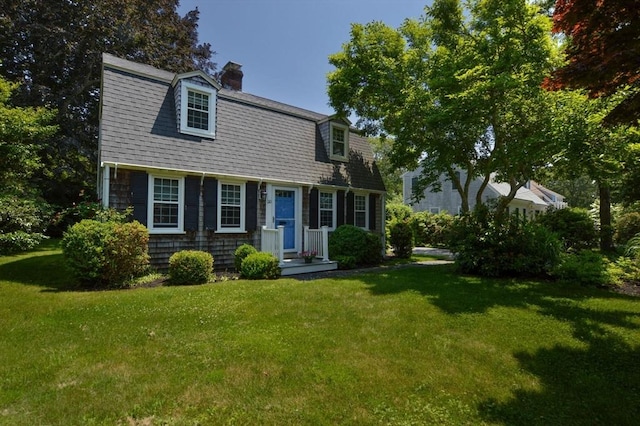 110 Teaticket Path, Falmouth, MA 02536 - colonial inspired home featuring a front lawn, a chimney, and a gambrel roof