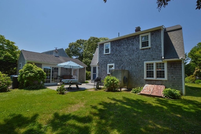 110 Teaticket Path, Falmouth, MA 02536 - rear view of house featuring a patio, a chimney, and a yard