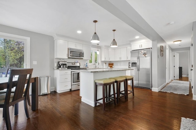 kitchen with stainless steel appliances, plenty of natural light, dark wood-style flooring, and recessed lighting