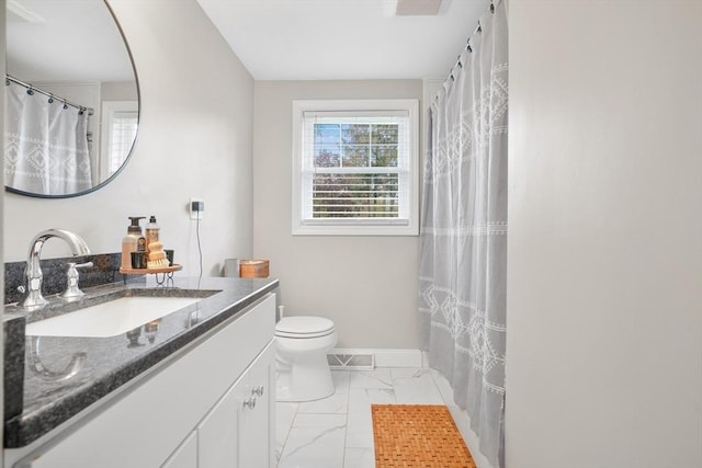 bathroom featuring marble look tiles, toilet, vanity, and baseboards