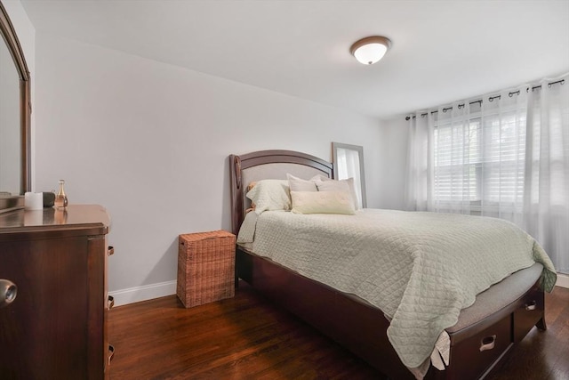 bedroom with baseboards and wood finished floors