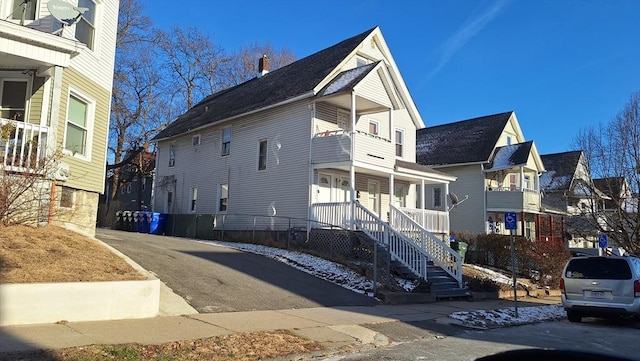 view of side of property featuring covered porch