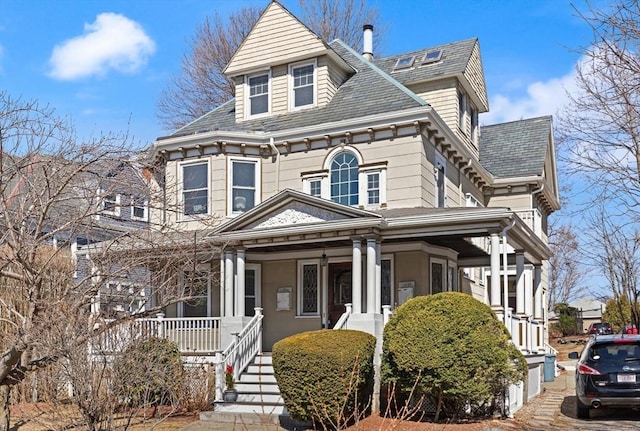 view of front of house with a high end roof and covered porch