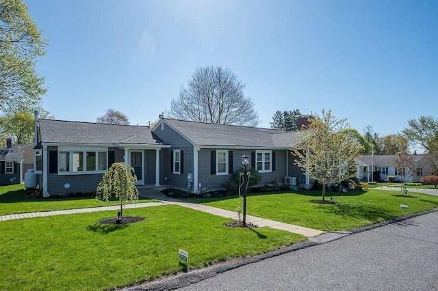 single story home featuring a chimney and a front lawn