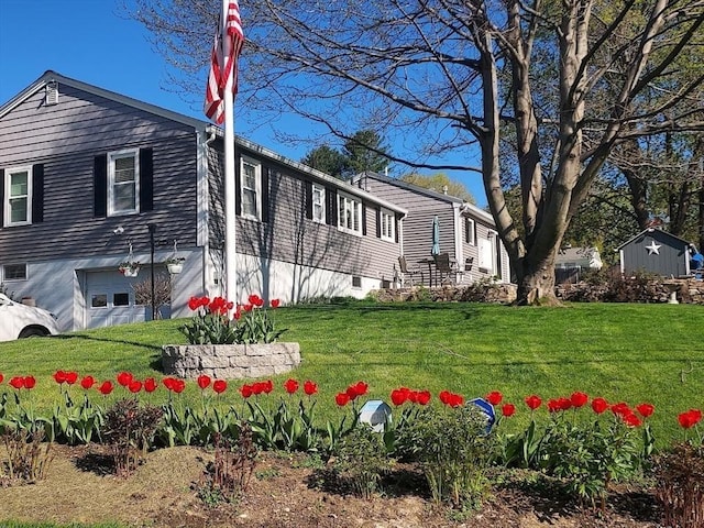 view of front of house with a garage and a front lawn