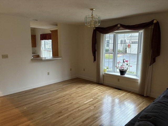 interior space with a notable chandelier and light hardwood / wood-style floors