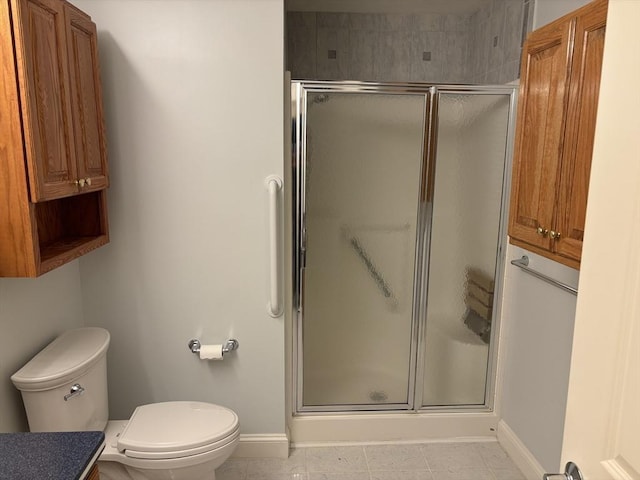 bathroom with tile patterned floors, toilet, and walk in shower