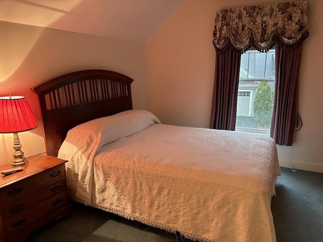 carpeted bedroom featuring vaulted ceiling