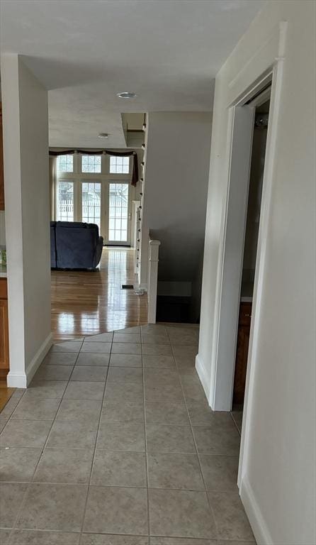 corridor with light tile patterned floors