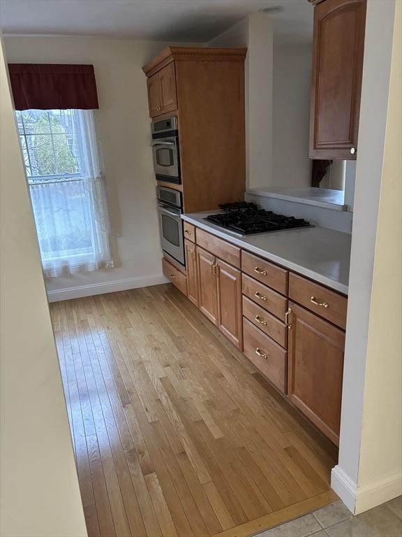 kitchen with gas cooktop and light hardwood / wood-style flooring