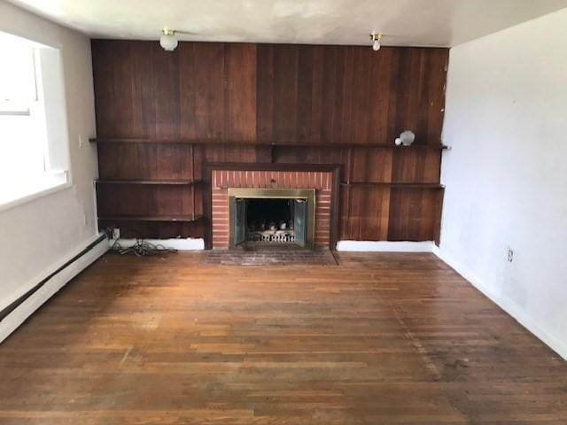 86 Seabrook Rd, Barnstable, MA 02601 - unfurnished living room featuring a fireplace, wood finished floors, baseboards, and baseboard heating