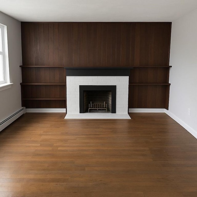86 Seabrook Rd, Barnstable, MA 02601 - unfurnished living room featuring wood finished floors, a brick fireplace, and baseboards