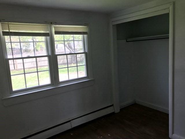 86 Seabrook Rd, Barnstable, MA 02601 - unfurnished bedroom featuring a baseboard heating unit, dark wood-style flooring, and baseboards