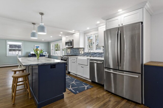 50 Deerfield Rd, Barnstable, MA 02655 - kitchen featuring white cabinets, stainless steel appliances, a center island, and tasteful backsplash