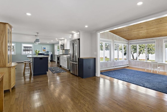 50 Deerfield Rd, Barnstable, MA 02655 - kitchen with a baseboard radiator, a kitchen bar, stainless steel appliances, a kitchen island, and white cabinetry