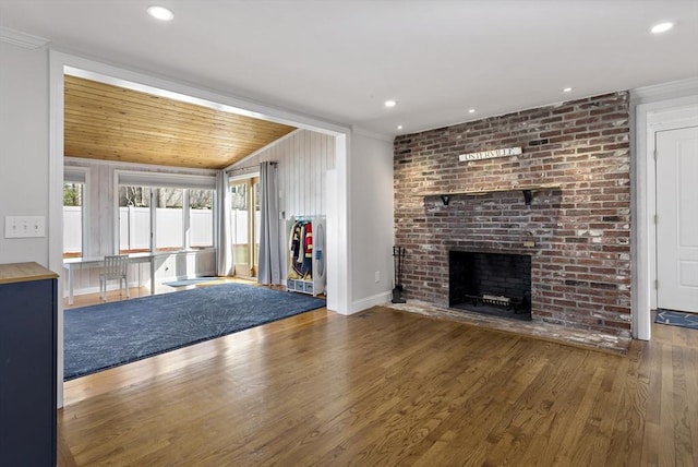 50 Deerfield Rd, Barnstable, MA 02655 - unfurnished living room with crown molding, wood finished floors, a brick fireplace, baseboards, and recessed lighting