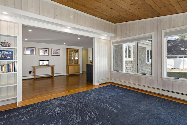 50 Deerfield Rd, Barnstable, MA 02655 - spare room with wood walls, a baseboard heating unit, wooden ceiling, a baseboard radiator, and wood finished floors