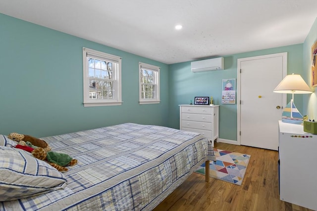 50 Deerfield Rd, Barnstable, MA 02655 - bedroom with a wall mounted AC, baseboards, and wood finished floors