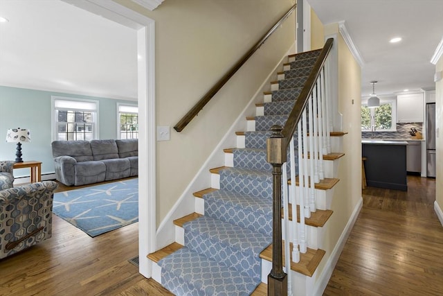 50 Deerfield Rd, Barnstable, MA 02655 - staircase featuring baseboards, crown molding, and wood finished floors