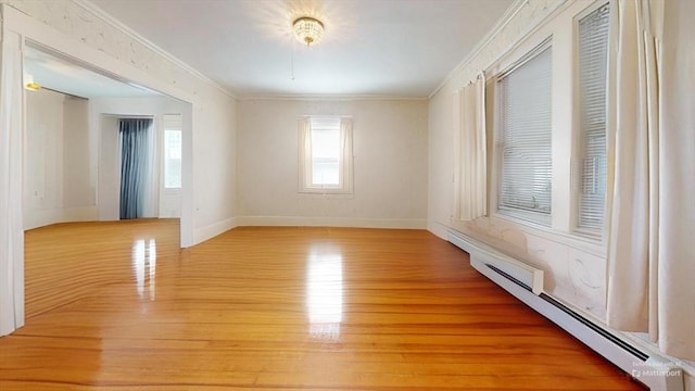 118 Colby Rd, Quincy, MA 02171 - empty room featuring baseboard heating, crown molding, and light wood-type flooring