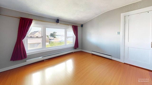 118 Colby Rd, Quincy, MA 02171 - spare room featuring baseboard heating, wood finished floors, and vaulted ceiling