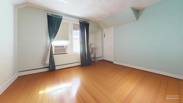 118 Colby Rd, Quincy, MA 02171 - additional living space with vaulted ceiling, cooling unit, baseboard heating, and wood finished floors