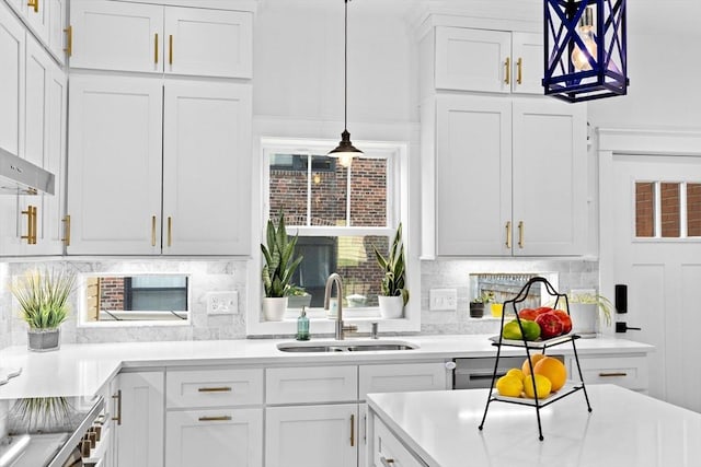 kitchen with a sink, backsplash, and white cabinetry