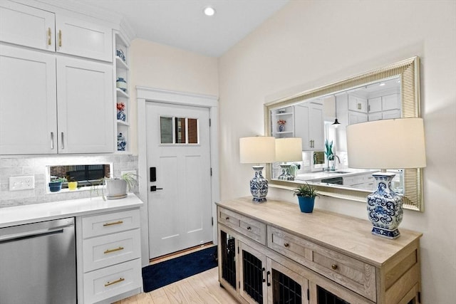 interior space featuring white cabinets, open shelves, decorative backsplash, and dishwasher