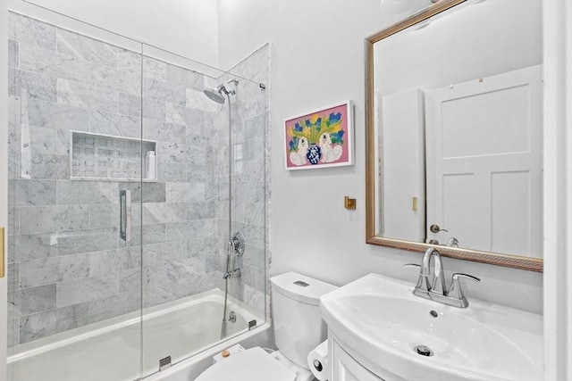 full bath with vanity, enclosed tub / shower combo, and toilet