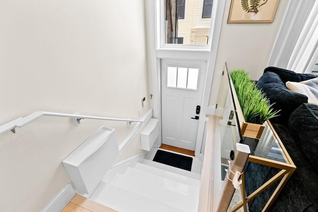 doorway featuring baseboards