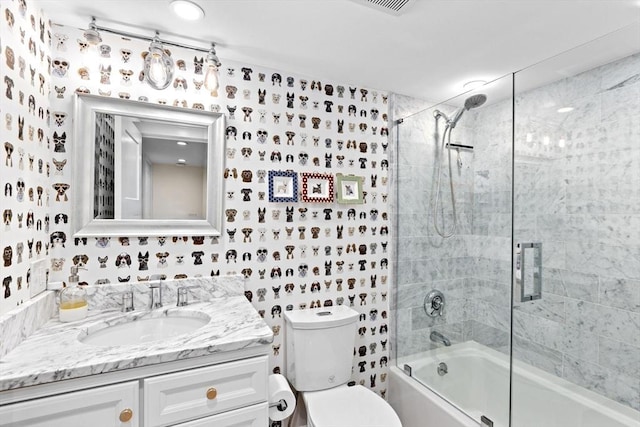 bathroom with vanity, combined bath / shower with glass door, and toilet