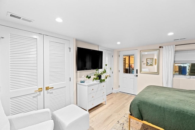 bedroom featuring recessed lighting, visible vents, and light wood finished floors