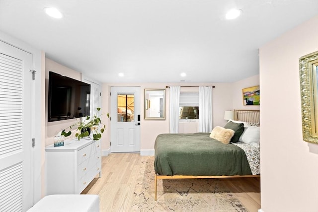 bedroom with recessed lighting and light wood-style flooring