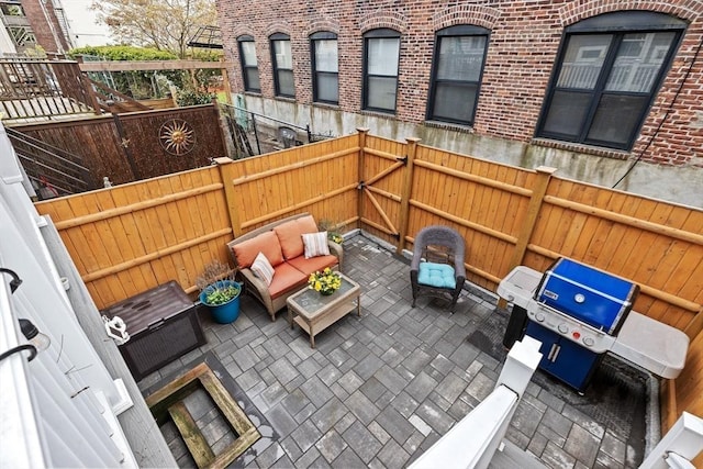 view of patio with an outdoor hangout area, grilling area, and a fenced backyard