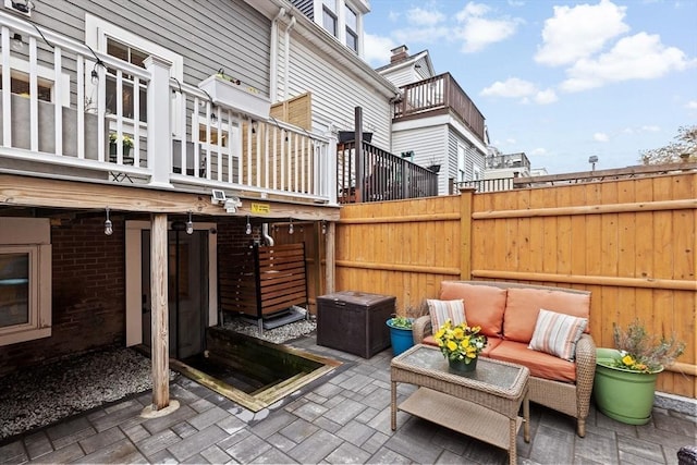 view of patio featuring an outdoor living space and fence