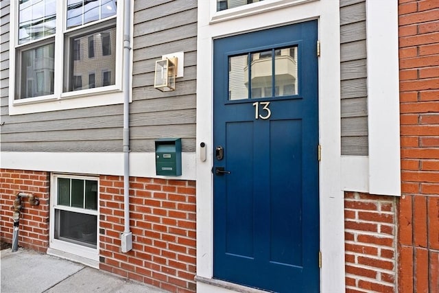 view of exterior entry with brick siding