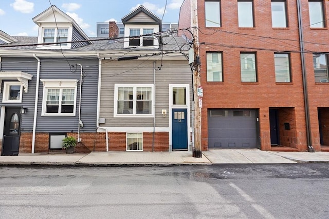 view of front facade with brick siding and a garage