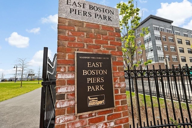 community / neighborhood sign with fence