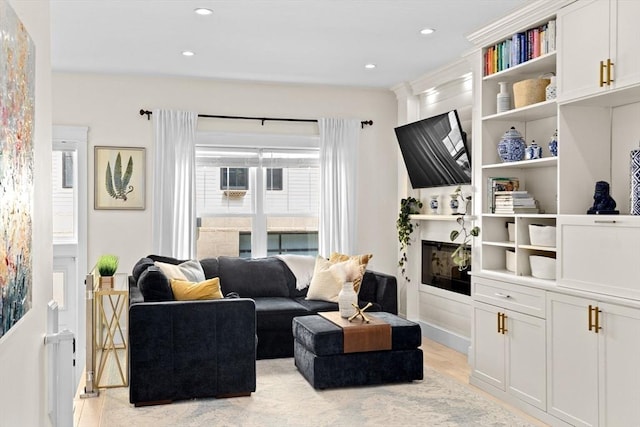 living area featuring light wood-type flooring and recessed lighting