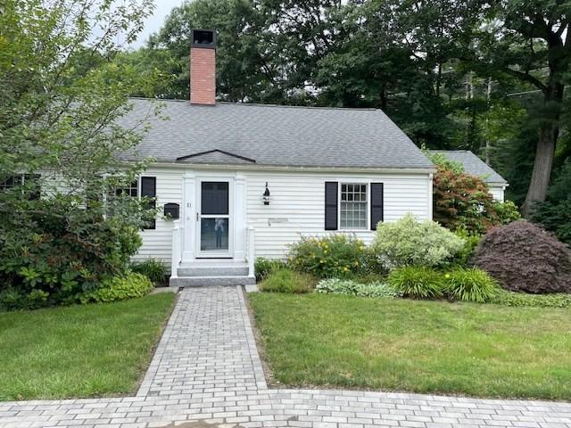 cape cod house with a chimney and a front lawn
