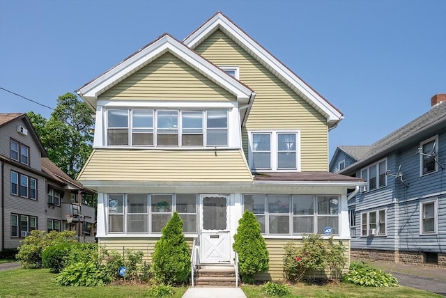 18-20 Eldridge St, Springfield, MA 01108 - view of front facade featuring a sunroom and entry steps